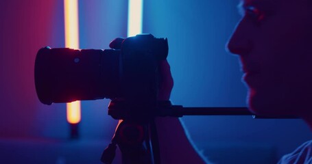 Photographer eye looking through viewfinder of camera in studio - close up
