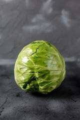 Fresh raw whole cabbage on black table. Organic healthy food. With copy space
