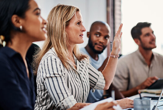 I have a question...an attractive businesswoman asking a question during a strategy meeting in the boardroom.