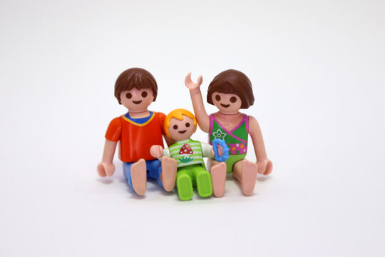 Playmobil dolls. Toys, figures. Happy kids. Isolated. 
Siblings. Brother, sister and little brother. Family. Family love. Small children. Childhood. Games. Family photo.