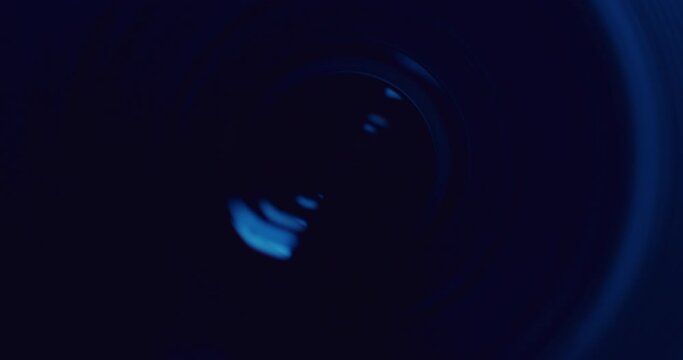 Close up of light shining into a glass camera lens