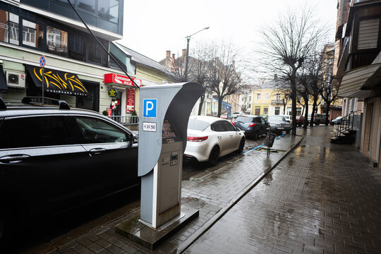 Ivano-Frankivsk, Ukraine - March, 2023: Parking machine in rainy city street.