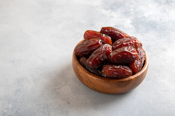 Date fruits in wooden bowl,top view
