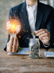 Businessman hand showing creative business strategy with light bulb in office.