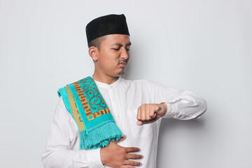 An Asian Muslim man feels so thirsty because of the hot weather during the summer season while fasting ramadhan.