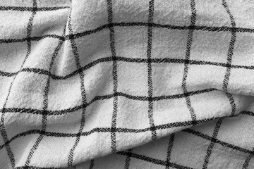 Classic black and white checkered kitchen towel texture. Crumpled fabric textile background with visible weave and thread detail. Ideal for web, print, packaging or for any other design project