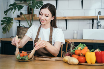 Woman preparing healthy food in her kitchen.