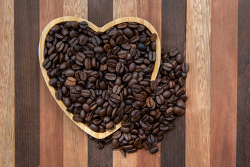 coffee beans in heart-shaped tra,y representing love of coffee