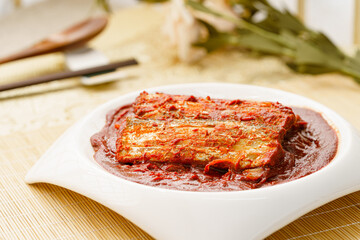 Korean style braised hairtail on a simple background