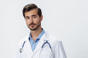 Man doctor in white coat with stethoscope and eyeglasses on white isolated background looking into camera, copy space, space for text, health