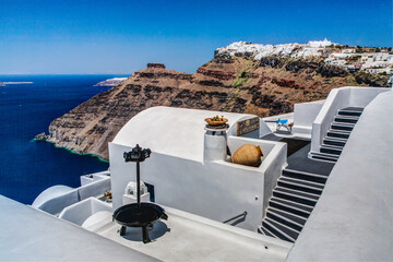 oia city rooftop with stairs and view of Skaros rock