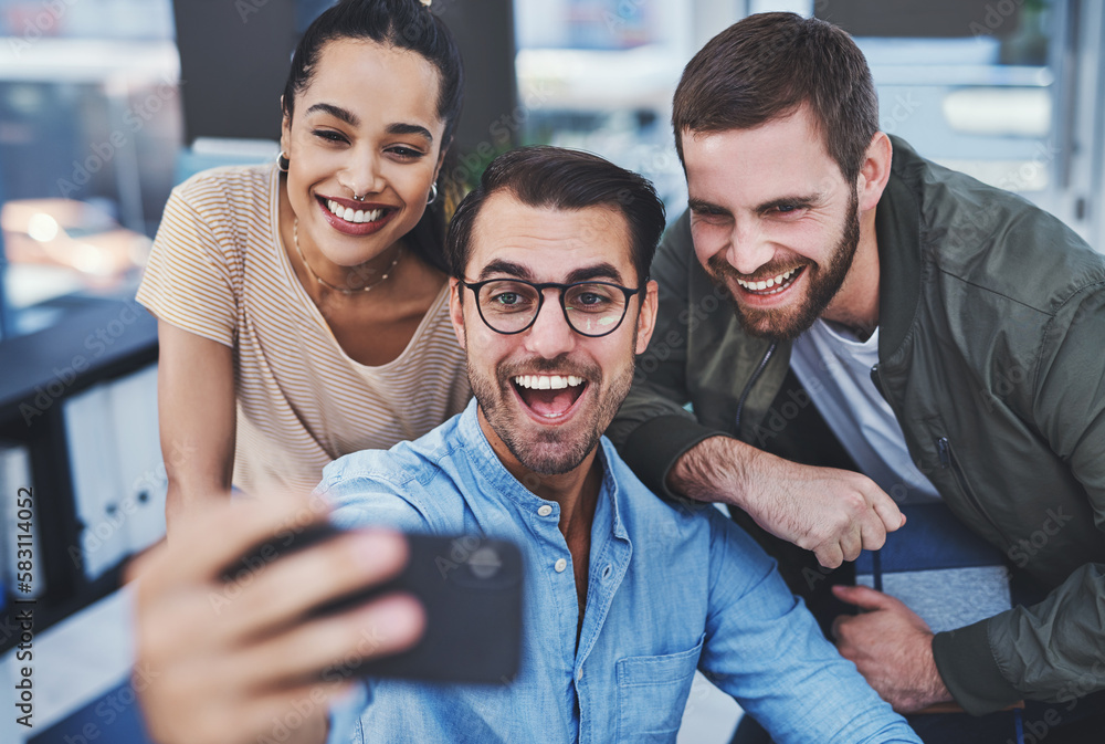 Poster we have fun while working hard. a group of designers taking selfies together in an office.