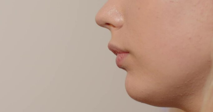 Close-up of teenager face without eyes. Secret message delivered in a confidential atmosphere. Space for text. Teen mouth talks about problems to social services.