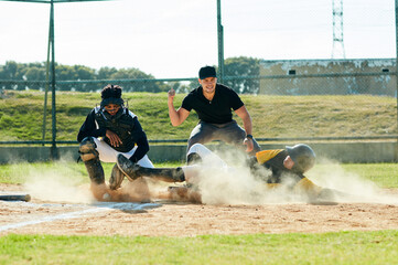 Sliding into base is his thing. Full length shot of a young baseball player reaching base during a match on the field.