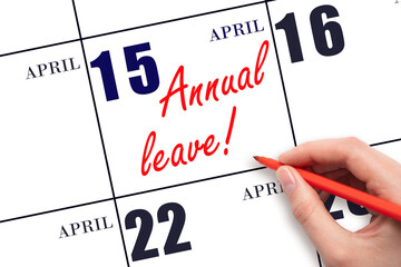Hand writing the text ANNUAL LEAVE and drawing the sun on the calendar date April 15