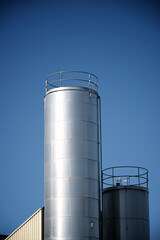 Two metal tanks in a factory