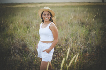 Young Woman Enjoying a Serene Moment in a Field of Long Grass