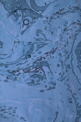 Close up of original beautiful unique marble pattern paper for interior of book cover, abstract design blue colour tones created ancient texture oil paint and turps technique of  mix swirl on water fl