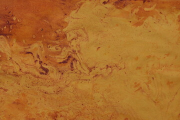 Close up original beautiful unique marble pattern paper  interior of book cover, fabric abstract design orange colour tones created ancient texture oil paint turps technique of  mix swirl on water 