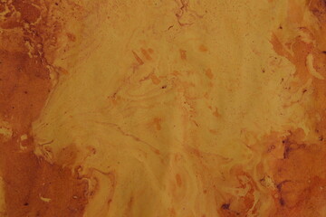 Close up original beautiful unique marble pattern paper  interior of book cover, fabric abstract design orange colour tones created ancient texture oil paint turps technique of  mix swirl on water 