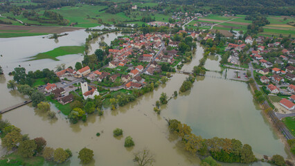 AERIAL Autumn flooding around rural village with large areas of muddy floodwater