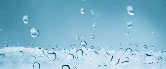 Minimal light backdrop with rain droplets on white glass. Light wet window with rainy drops closeup...