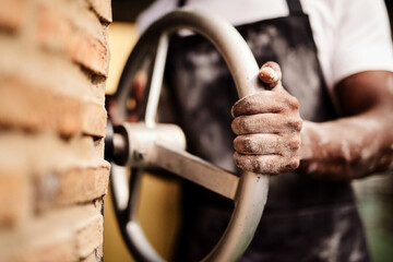 Put in the work to make your business succeed. a male baker working in his bakery.