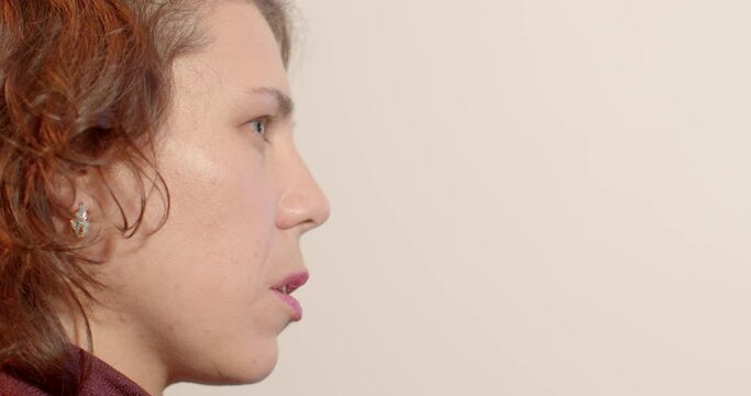 Close-up of woman face profile. Portrait of a psychotherapist during trust and confidence session, lifestyle indoors. Skills to develop better relationships, talking. Space for text. 