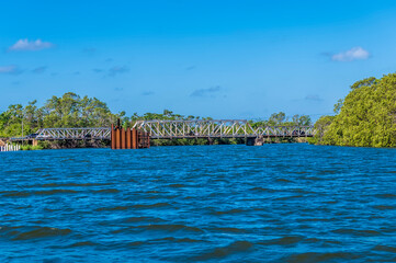 A view of a road bridge over the Belize River at the mouth in Belize from the sea on a sunny day