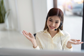 Portrait of happy smiling female customer support phone operator at workplace. Smiling beautiful...