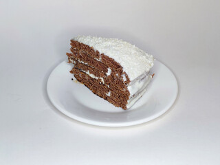 a piece of chocolate layer cake with cream on a white plate