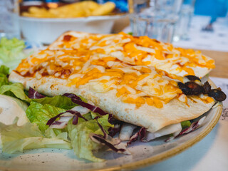 mexican tacos, tortilla, wrap burrito cheddar on top and green salad. Fast food.