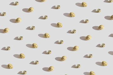 Minimal style pattern made of quail eggs on pastel background with shadow. Easter creative concept.