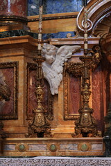 Fototapeta na wymiar Santi Carlo e Ambrogio al Corso Basilica Altar Detail with Sculpted Angel and Candle Holder in Rome, Italy