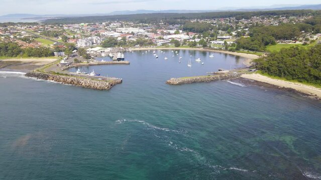 Aerial drone view of Ulladulla in the City of Shoalhaven, NSW, Australia, rising up over Ulladulla Harbour 