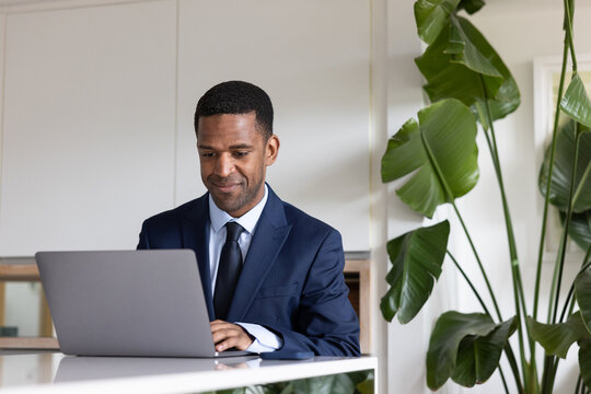 African American business executive using a coworking office space