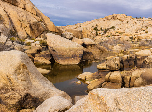 Historic Barker Dam and Monzogranite Rock Formations on The Barker Dam Trail, Joshua Tree National Park, California, USA