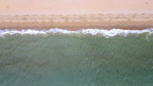 Aerial view of sand beach and water surface texture.