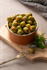 Green olives in a bowl. Delicious, marinated olives. 