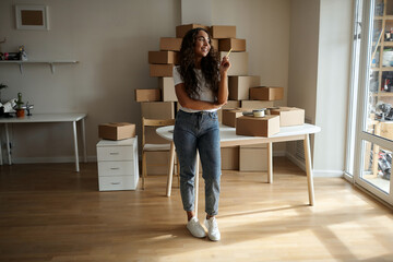African business woman working in the office screaming proudly, celebrating victory and success, very excited with raised hands. Living emotions