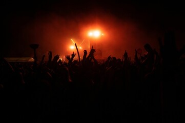 Beautiful shot of hand silhouettes of a crowd at a concert