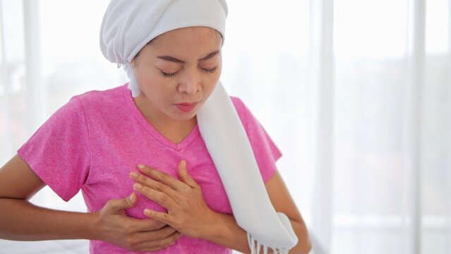 Breast cancer patients hold their breasts, feel the pain and fight breast cancer. Breast cancer awareness month,  Healthcare, world cancer day concept