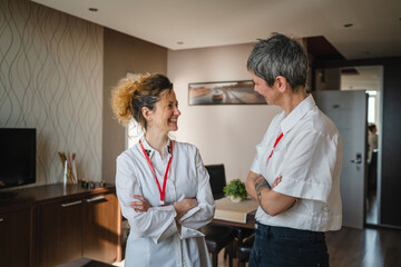 Two women happy caucasian female manager entrepreneur stand work