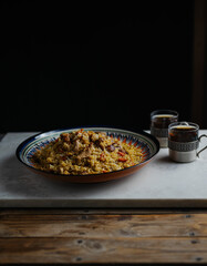 Uzbek pilaf with lamb and carrots and tea on the table