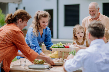 Multi generation family having outdoor garden party.