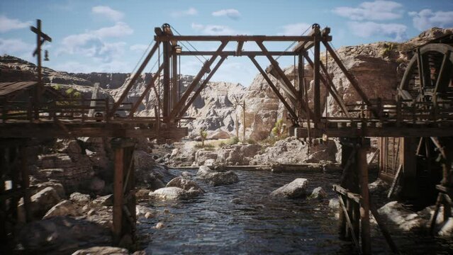 Camera flys trough a wooden bridge next to a lumber mill in a west town village