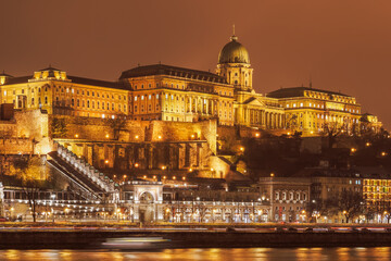 Budapest, Hungary Illuminated night view of Buda Castle Palatial venue, seen from the banks of river Danube.