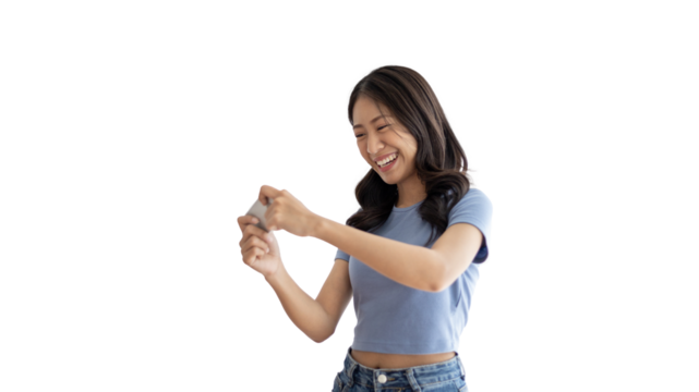 Asian woman playing games on mobile phone and wearing headphones having fun, Play games on the sofa in the living room on weekends, Resting at home, Comfort zone, Touch screen mobile phone.