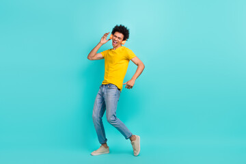 Fototapeta na wymiar Full size portrait of carefree overjoyed young man dancing enjoy new single hit isolated on emerald color background