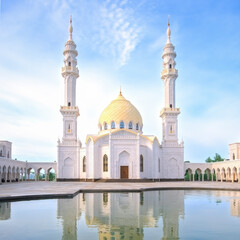 White Mosque, Bolgar, Tatarstan. A beautiful white mosque with domes and minarets against a bright blue sky.